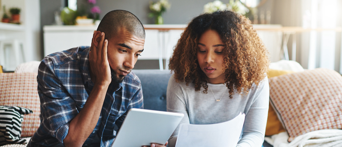 Stressed, worried and anxious couple doing finances, budget and internet banking. Upset couple looking at savings and online investment. Man and woman struggling with debt, loan and bond payment.