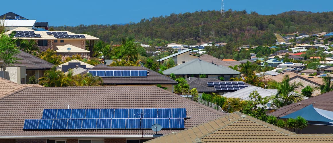 Solar panels on roofs all over a neighborhood.