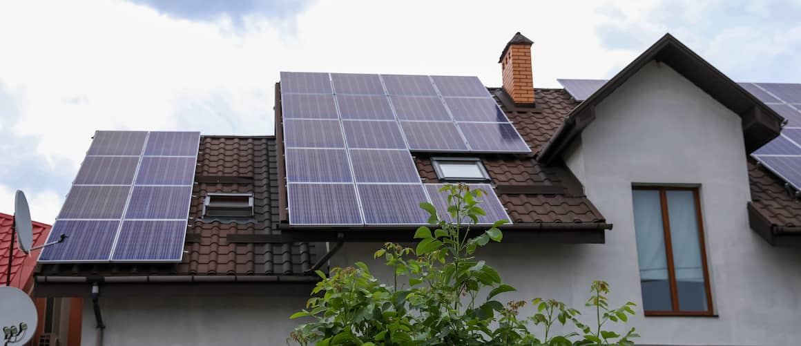 House shown with solar panels during the day.