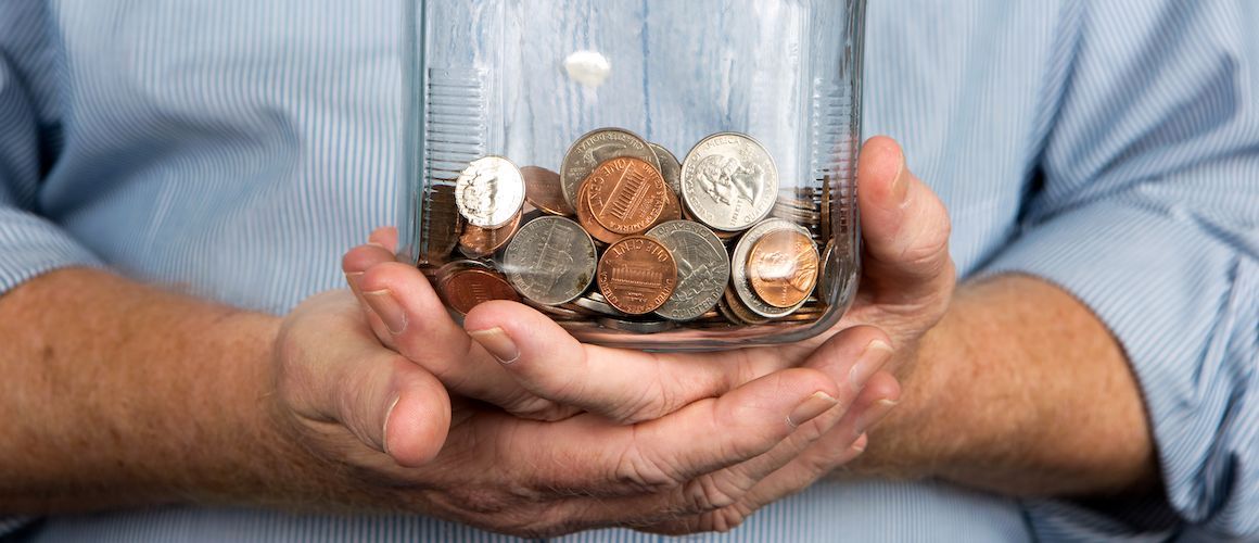 Man holding money jar.